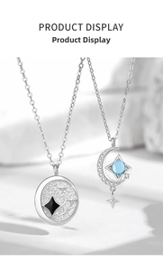 Detail of 925 sterling silver star and moon pendants with blue gemstone and black star inlay