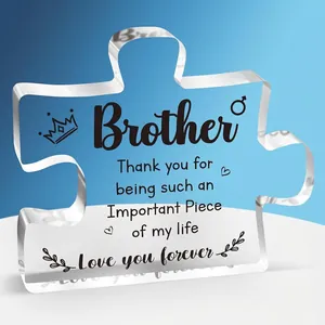 Macro shot of puzzle-shaped clear acrylic desktop ornament with heartfelt brother quote