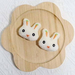 Accessoires de lapin en peluche blanche avec oreilles carottes sur plateau bois