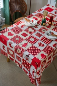 Detailed view of Christmas patchwork tablecloth featuring heart patterns and red plaid