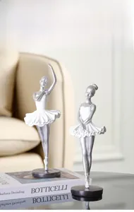 Set of two Nordic ballet dancer sculptures in silver and white on black round bases