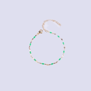 Golden lip chain bracelet with green enamel charms and adjustable lobster clasp