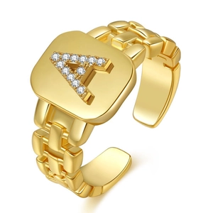 Macro detail of gold adjustable ring featuring a square face with diamond letter A