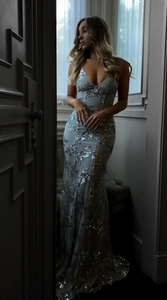 Detail of silver sequin evening gown showing the deep V-neck and mermaid silhouette