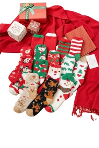 Christmas coral fleece socks with festive patterns of Santa, reindeer, and trees in a gift box