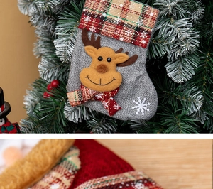 Detail of Christmas stocking with 3D reindeer, red plaid trim and snowflake embroidery