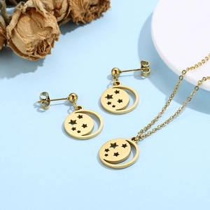 Close-up of golden hollow star and moon necklace and earrings jewelry set