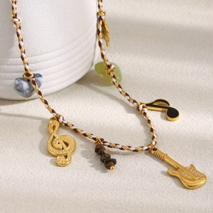 18K gold plated guitar pendant necklace with musical notes on a colorful woven rope