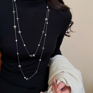 Detail of elegant double-layered silver floral necklace with sparkling diamond accents