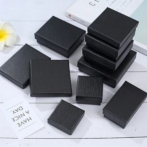 Macro shot of matte black jewelry boxes with brushed paper texture in various sizes