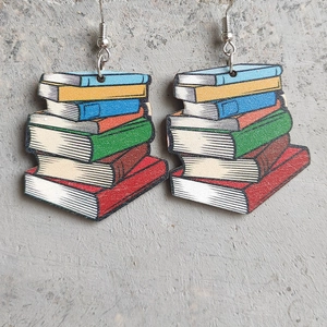 Colorful stacked books wooden earrings with metal hooks on a concrete background