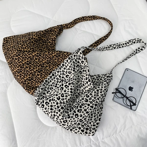 Detail of leopard print corduroy tote bags in brown and black-white showing large capacity