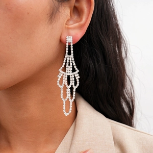 Close-up of model wearing silver tassel fan earrings with sparkling rhinestones