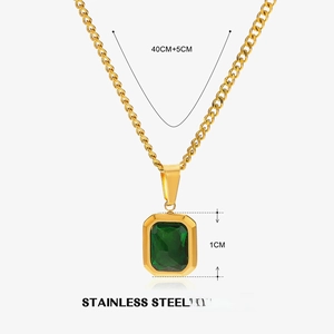 Detail of emerald green gemstone pendant on golden stainless steel link necklace