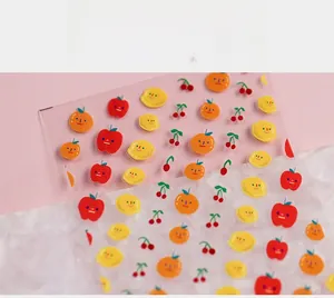 Detailed view of cute 5D fruit nail stickers with lemon, apple, and cherry patterns