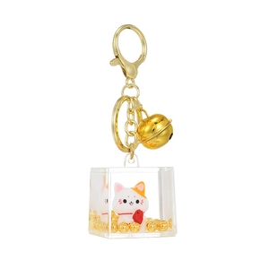 Golden fortune cat keychain with acrylic cube and liquid glitter in white background