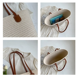 Detail view of woven tote bag with brown handles showing large capacity and interior space