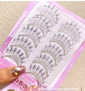 Detailed view of natural crisscross false eyelashes with clear bands in pink packaging