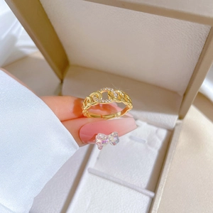 Macro shot of gold chain ring with sparkling crystals and adjustable band on hand