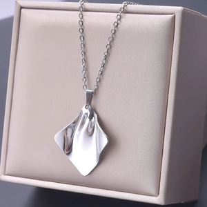 Macro shot of silver liquid metal geometric pendant on a minimalist necklace chain