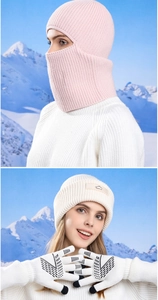 Detail of pink knitted balaclava hood with white touch-screen gloves and a winter beanie