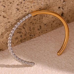 Detail showing two-tone twisted rope and polished flat surface on stainless steel cuff