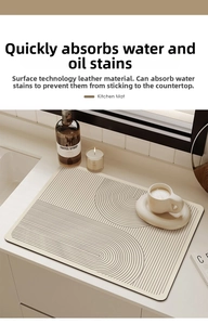 Detail view of cream kitchen drying mat with minimalist black lines on modern countertop