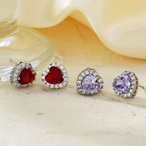 Elegant heart-shaped stud earrings with ruby red and lavender crystals in silver setting