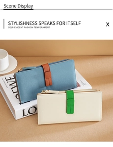 Chic long pebbled leather wallets in color-block designs displayed with lifestyle props