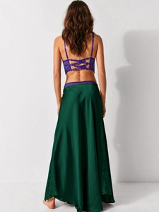 Detail of dark green satin skirt back with lace-up corset and buckle closure design