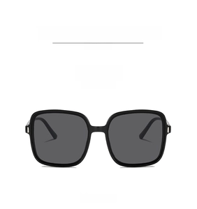 Front view detail of square oversized sunglasses with black frames and grey lenses
