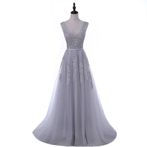 Detail of V-neck evening gown with lace appliques and multilayered tulle A-line skirt