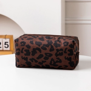Close-up of leopard print makeup bag fabric texture and metallic zipper detail