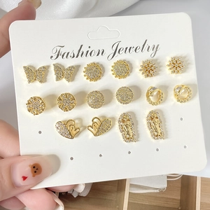 Close-up of 9-pair gold-plated stud earring set with zircon butterfly and flower designs