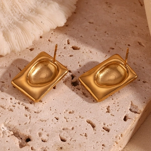 Macro view of 18K gold plated rectangular earrings with unique concave droplet texture