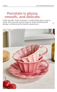 Detail of pink petal-shaped ceramic coffee cup with grooved texture and thick handle