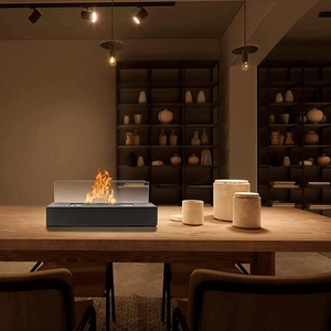 Close-up of rectangular tabletop fire pit with real flame and glass panels on wood table