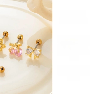 Detail of pink heart gemstone bow stud earrings with secure ball screw back closure