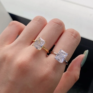 Close-up of radiant cut carbon diamond rings on hand in gold and silver finishes