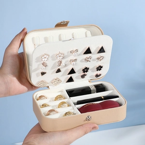 Portable beige PU leather jewelry box with double layer storage held in hand
