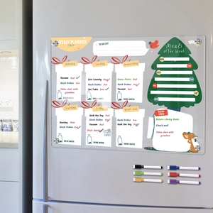 Close-up of magnetic acrylic weekly planner with Christmas design on a refrigerator