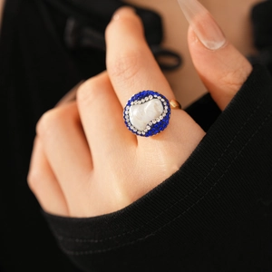 Macro shot of vintage baroque pearl ring with blue and white rhinestone halo