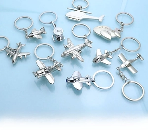 Close-up of polished silver alloy metal aircraft keychains in various aviation models