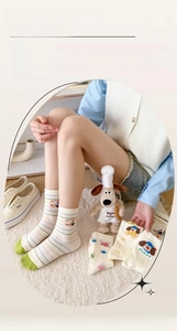 Detailed close-up of embroidered cartoon dachshund on striped cotton crew socks for women