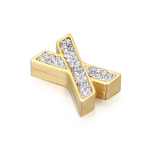 Detailed close-up of a gold-plated letter X pendant with sparkling crystal inlay