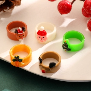 Detailed view of five-piece Christmas ring set with elk and tree resin charms