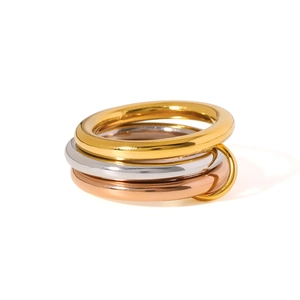 Three-tone stackable 18K gold plated rings with interlocking circles and polished finish