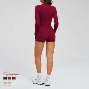 Women's burgundy athletic set featuring a zip-up long sleeve top and high-waist yoga shorts