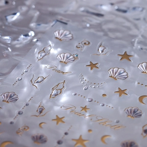 Pearlescent white nail stickers with gold shell and moon designs for elegant nail art