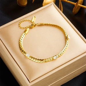 Close-up of gold titanium cuban chain bracelet featuring three rectangular white zircons